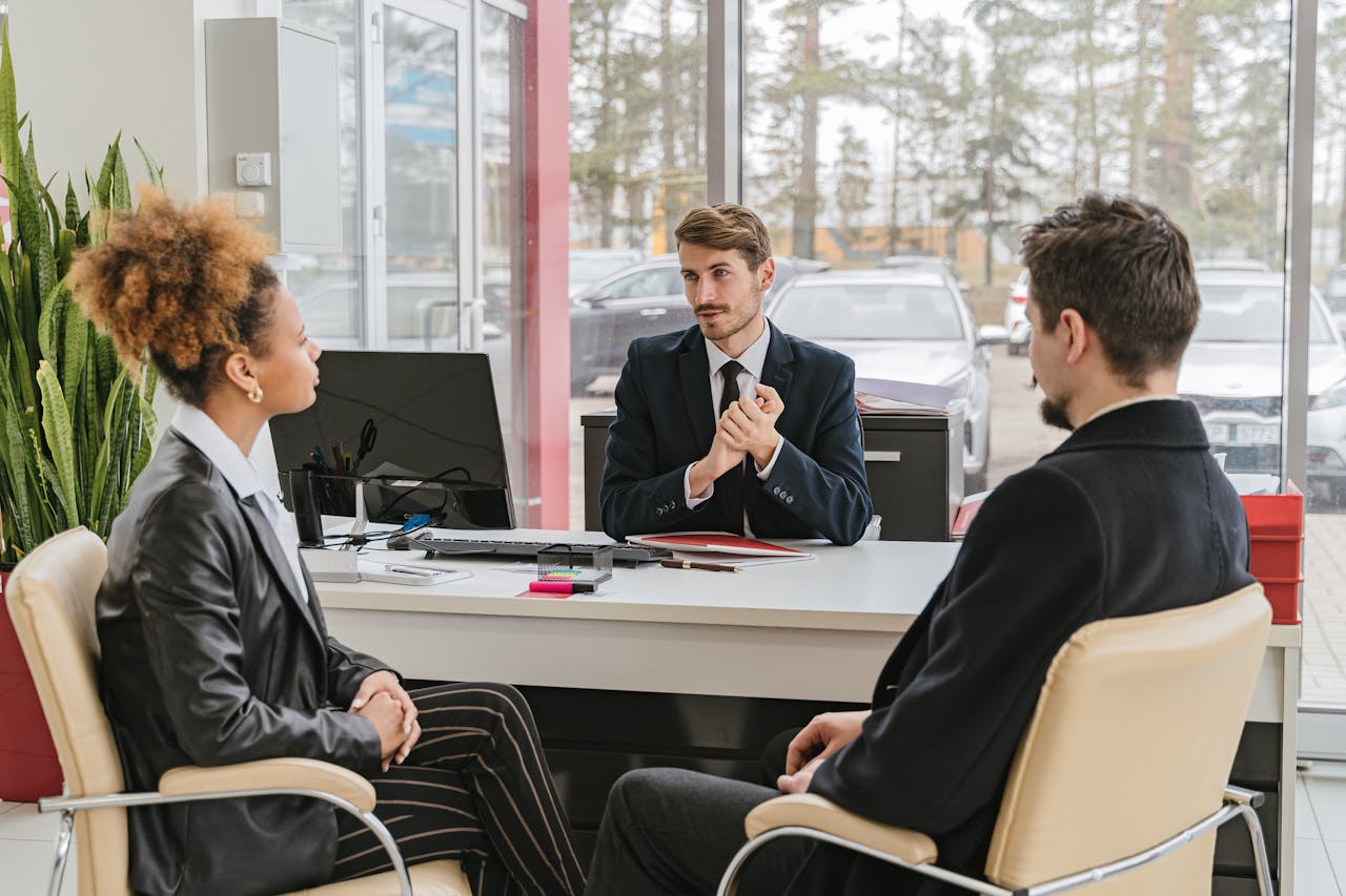 services-02 Professional meeting with clients at a modern office, discussing business solutions.